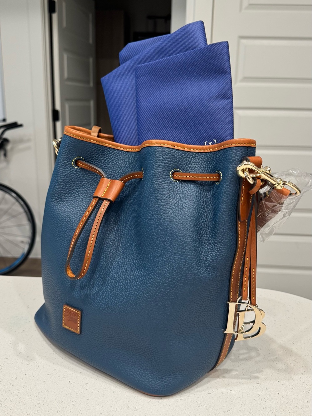 Dooney & Bourke Blue Pebble Leather Drawstring Bucket Bag with Tan Trim